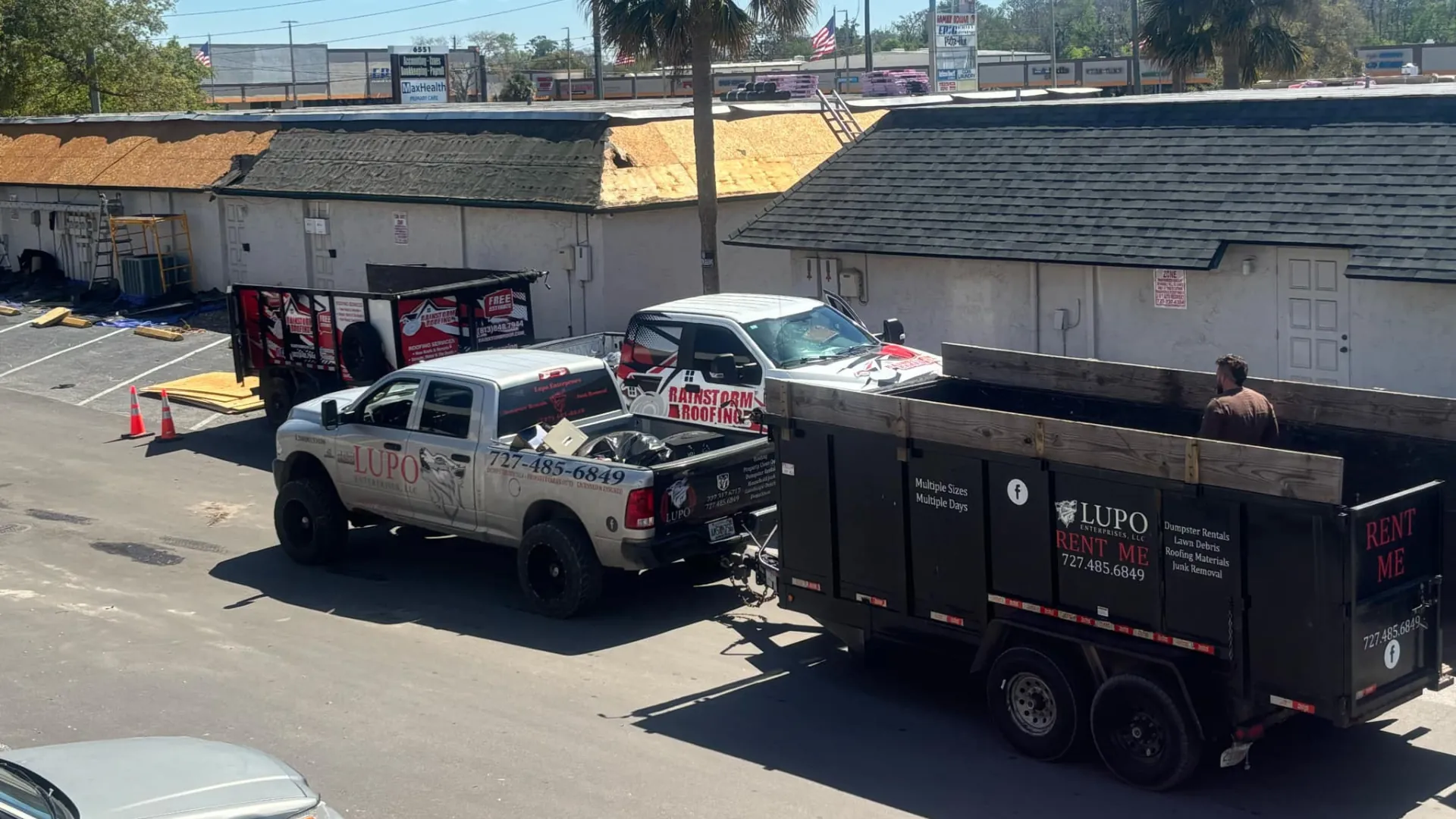 Lupo dump trailer and pickup truck at a roofing job site in Pasco County
