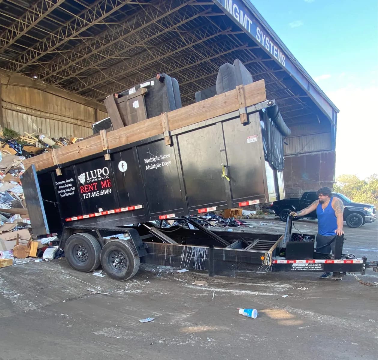 Lupo dump trailer unloading a full load of junk at a local disposal facility